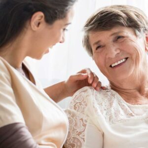 Caregiver enjoying conversation with female patient